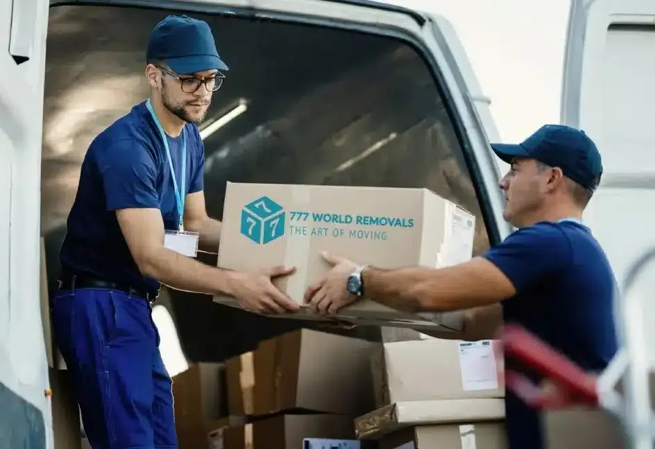 777 World Removals crew loading boxes into a van