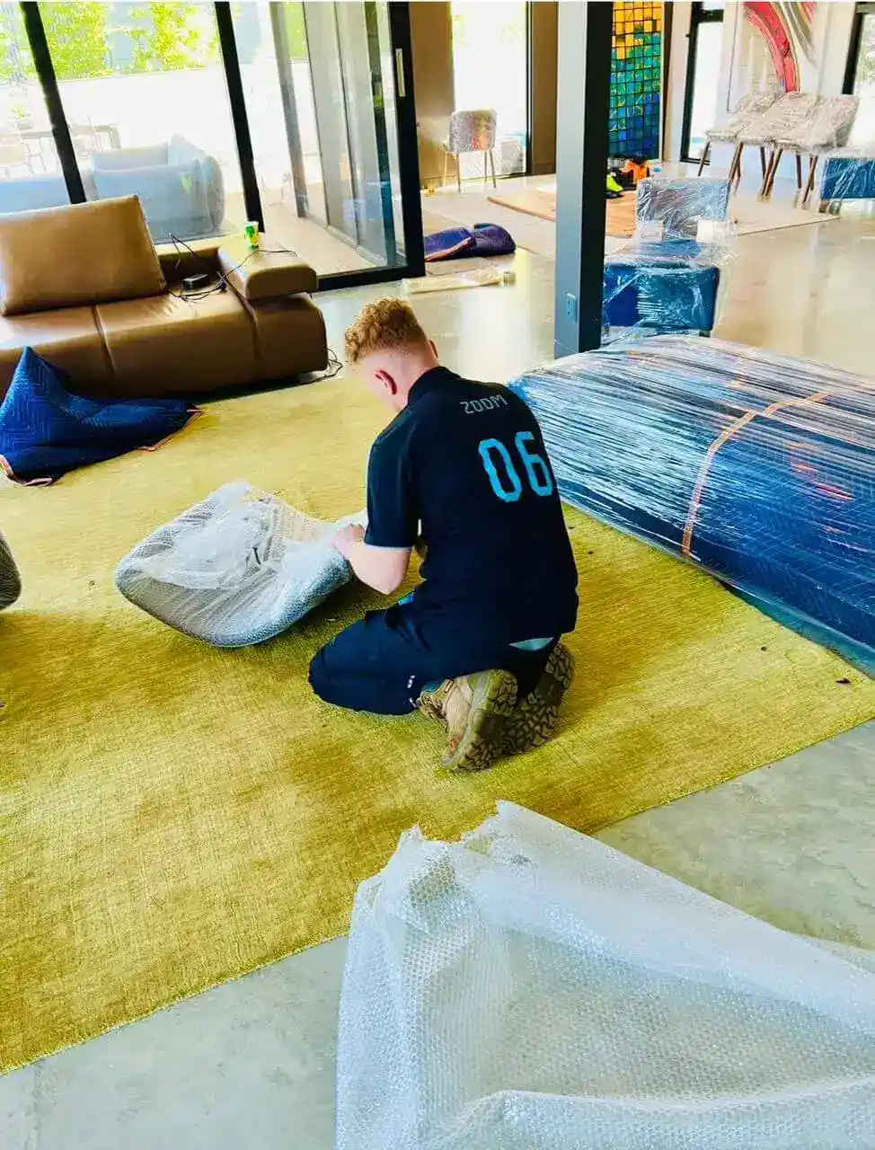 777 World Removals crew wrapping furniture before a Wollongong move